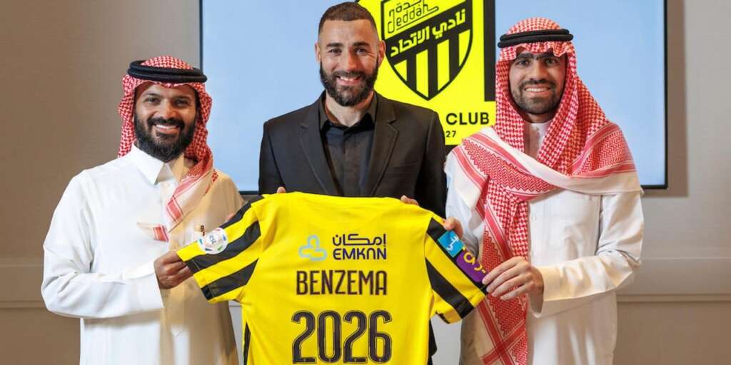 Karim Benzema psoing with his Al Ittihad Jersey after completing move