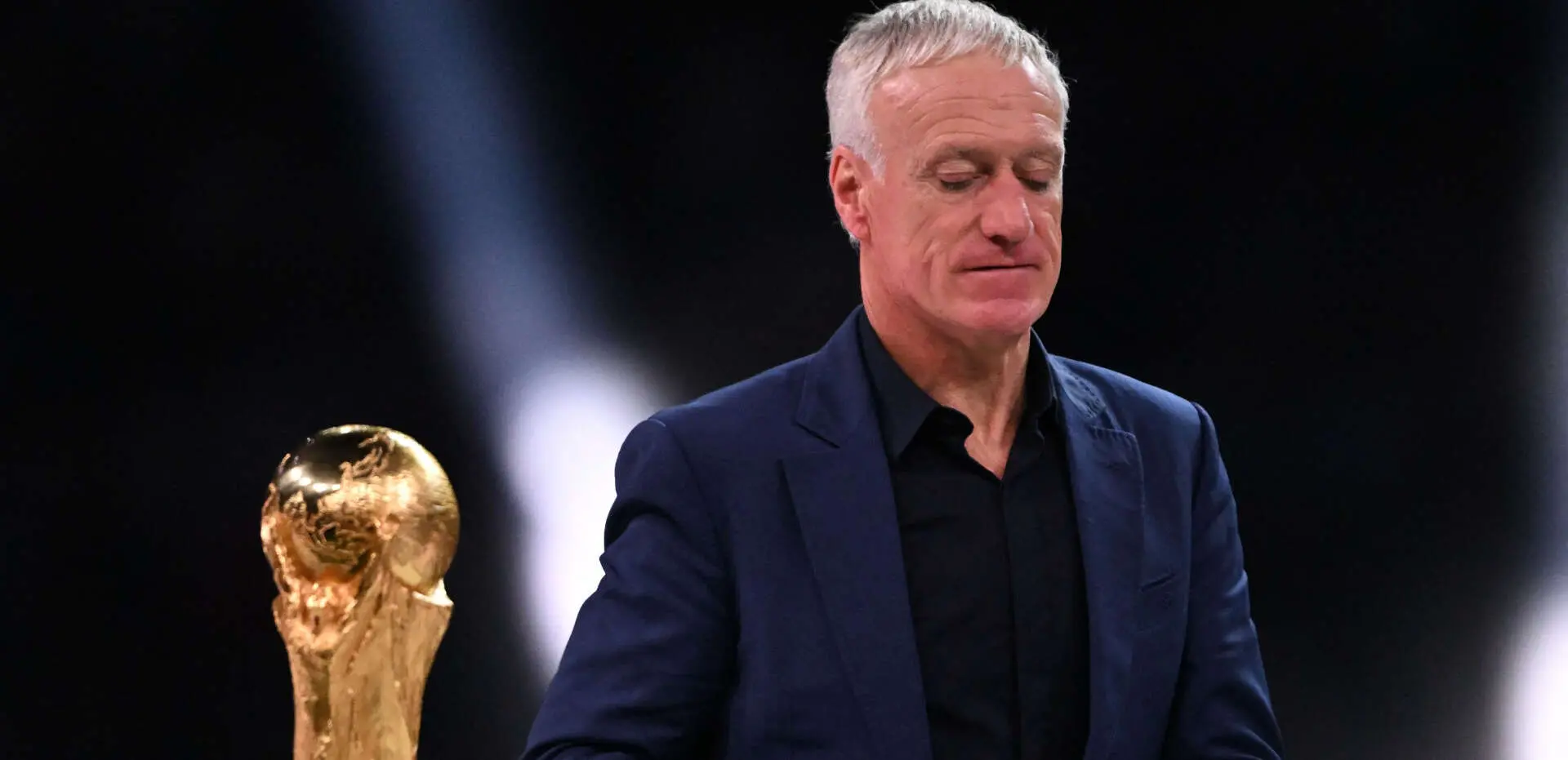didier deschamps walking by the world cup trophy