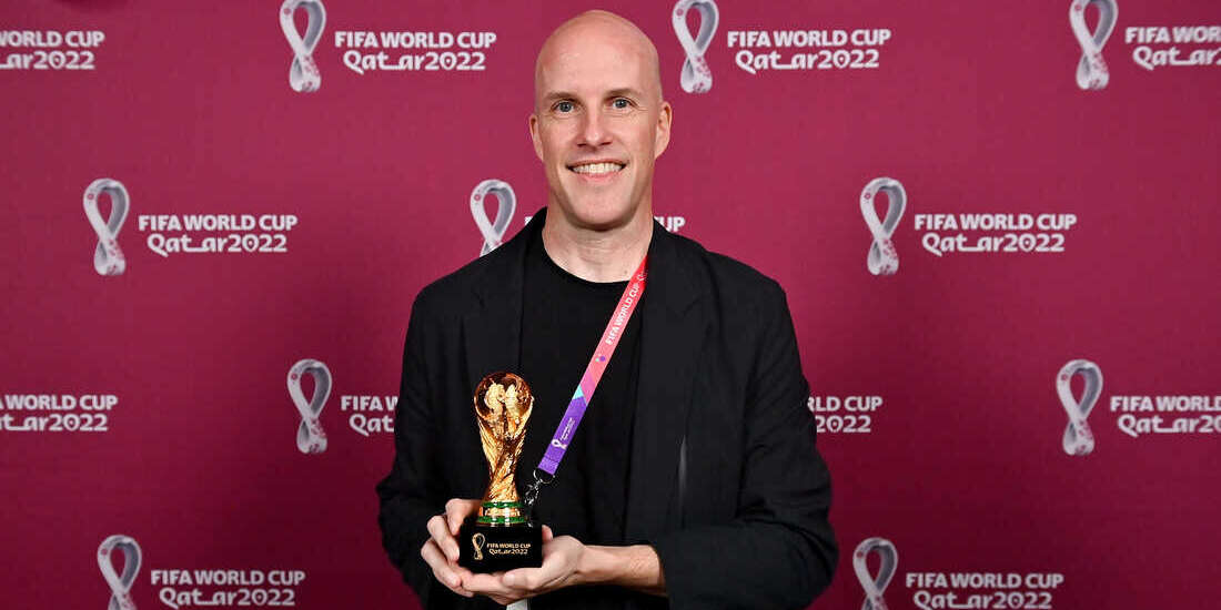 grant wahl holding his FIFA journalist award