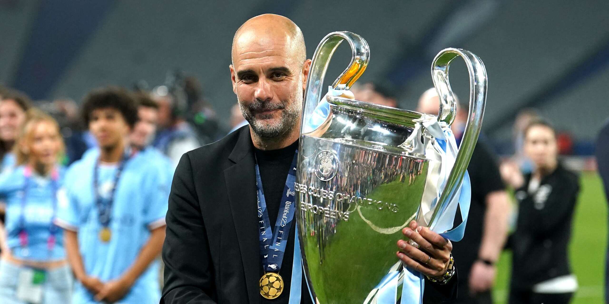 Pep Guardiola poses with Champions League Trophy